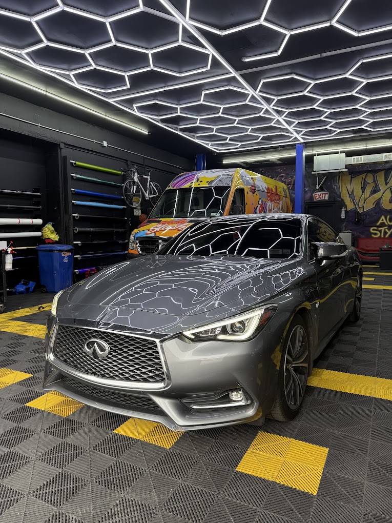 Infiniti coupe under Miyoshi's hexagon shop lights
