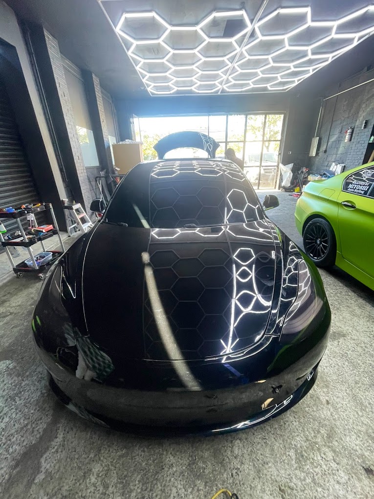 Black Tesla under the Miyoshi installation lights