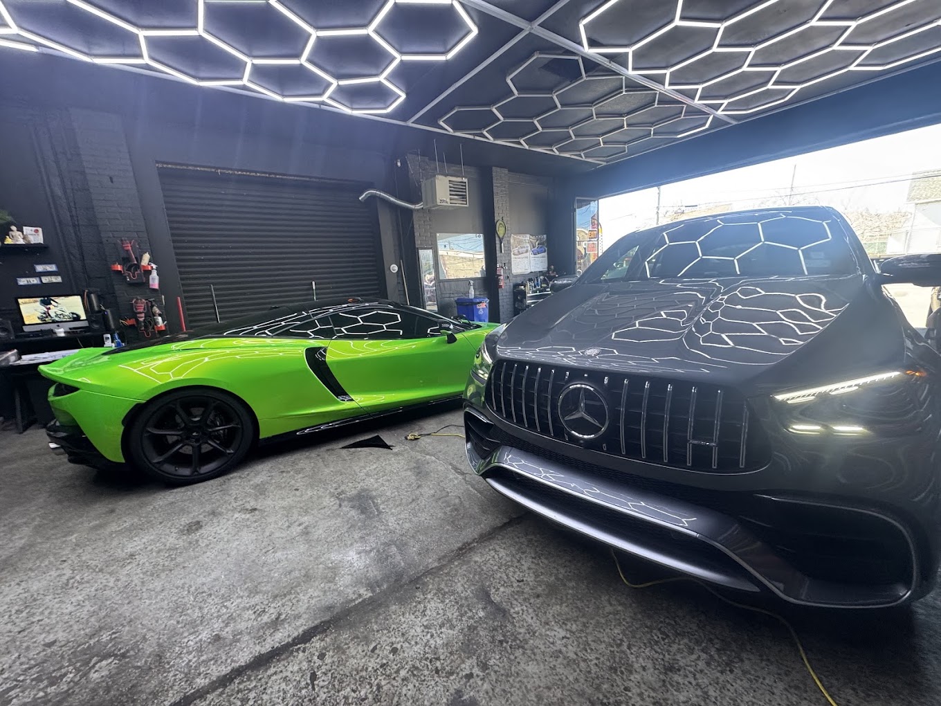 Green Corvette and black Mercedes-AMG inside Miyoshi Auto Styling